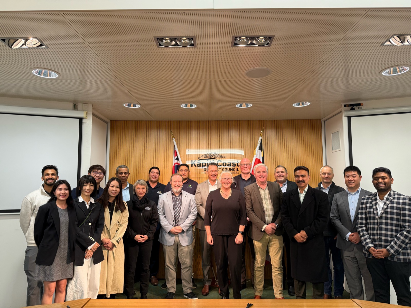 The TTAP team gathered in the Kāpiti Coast District Council chambers, with New Zealand and KCDC flags in the background — approximately 18 senior engineers, planners and advisors who lead every project.